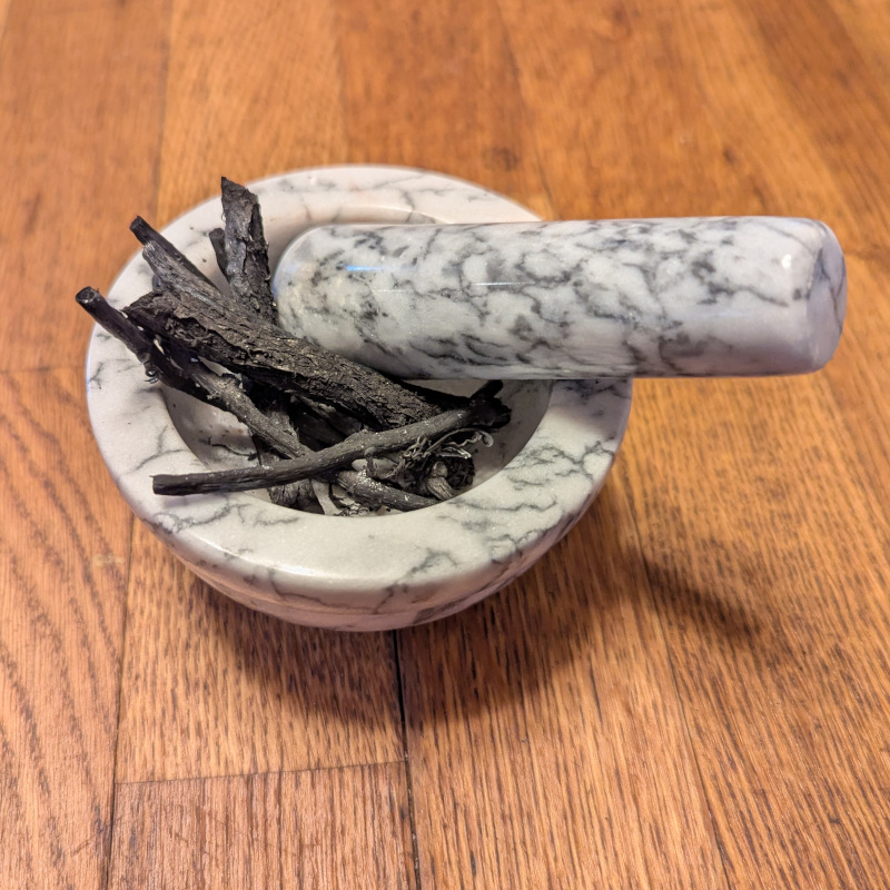 vine charcoal in a mortar and pestle